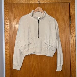 The Normal Brand Cropped Half Zip with pockets. Cream colored.Size L. Never worn